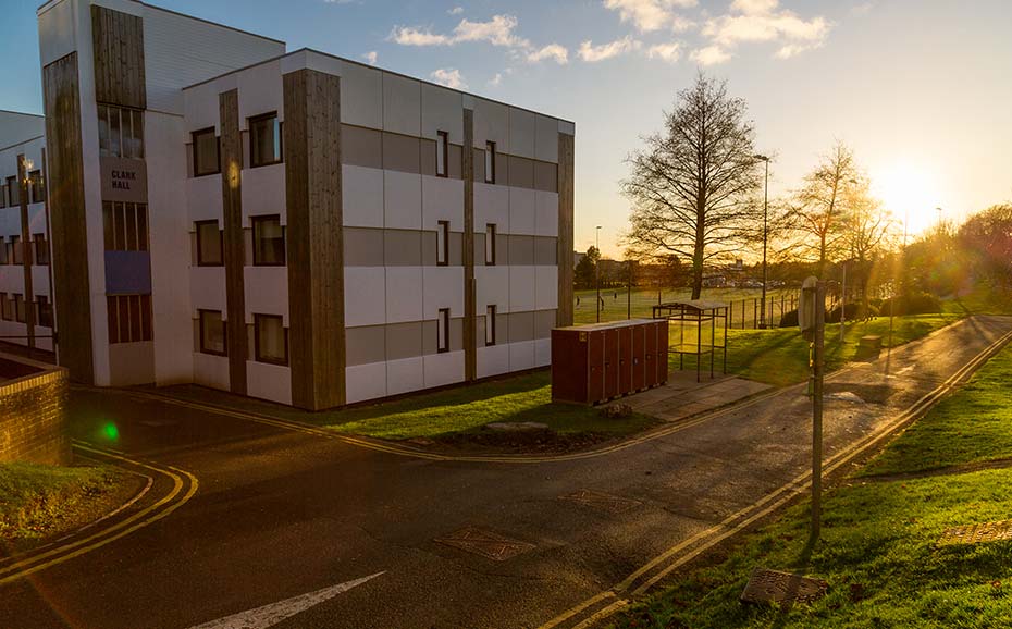 student halls at sunset with a view of the 3g pitch
