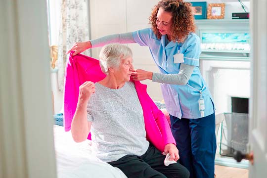 Nurse helping an elderly patient