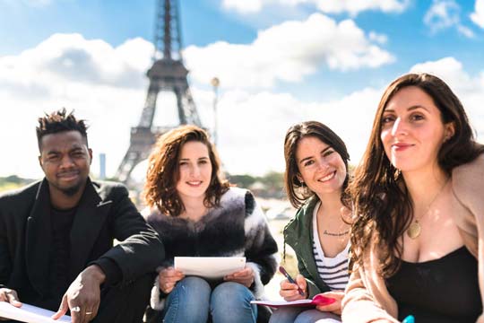 Four trainee language teachers on a subject knowledge enhancement trip the Eiffel Tower in Paris