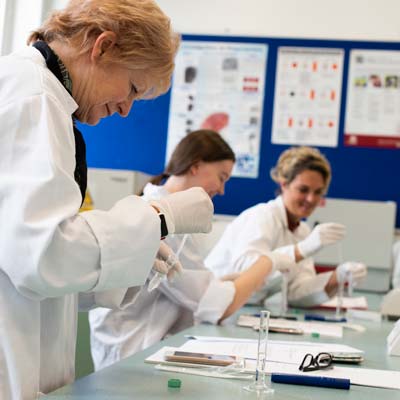 Students and lecturer analyse evidence in the forensics lab
