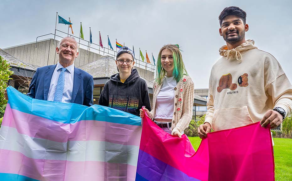 Students and staff with flags to mark LGBTQ+ week